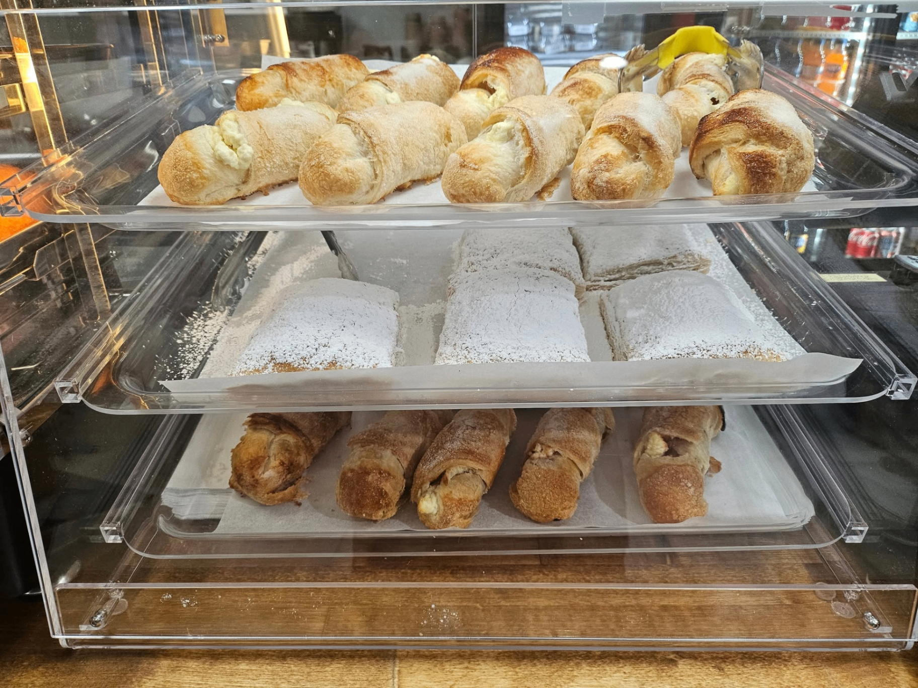 Bakery case full of quesitos and pastries